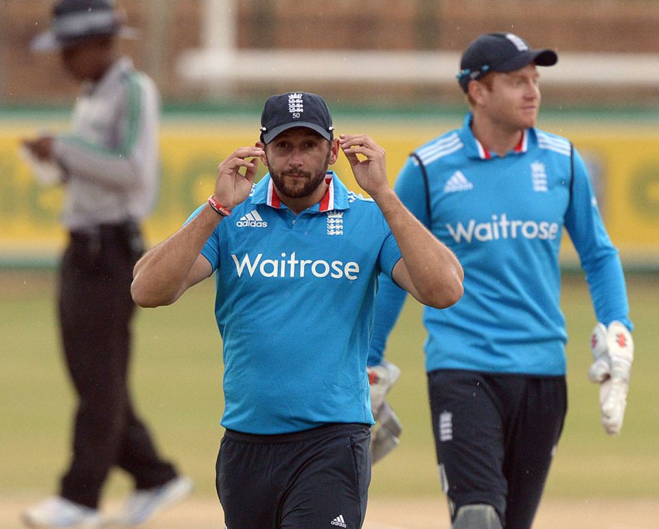 Tim Bresnan leaves the field as rain falls