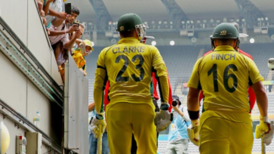 Michael Clarke walks out to open the innings with Aaron Finch