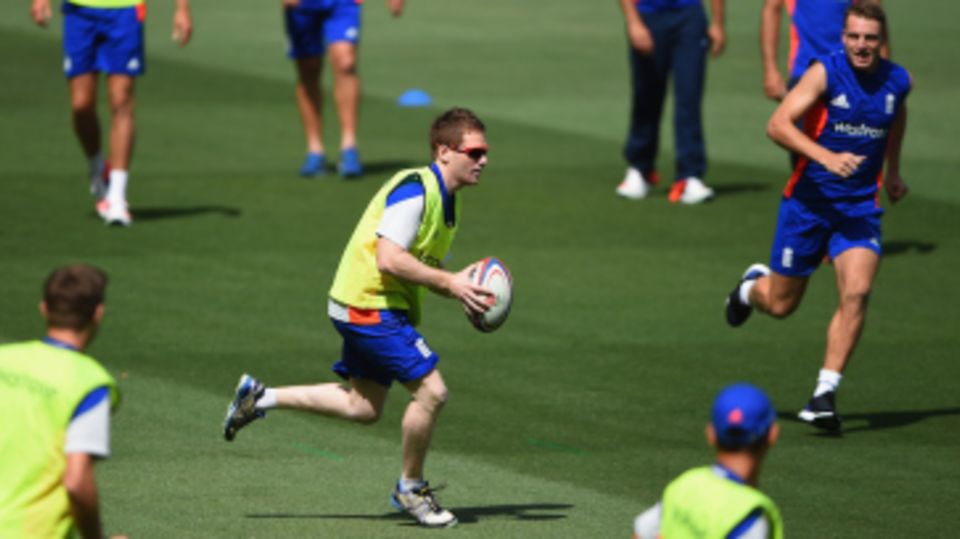 In focus: England captain Eoin Morgan runs with a rugby ball