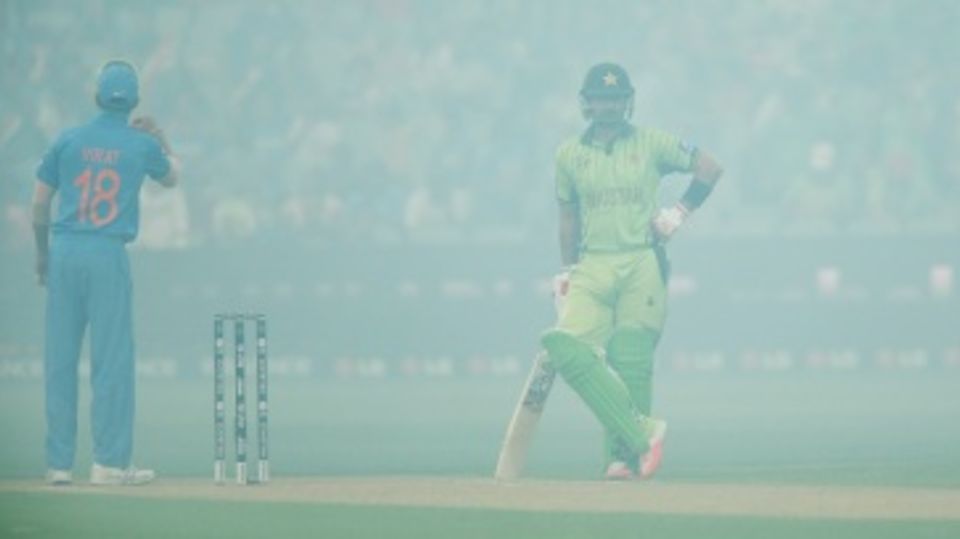 Ahmed Shehzad and Virat Kohli wait for the smoke to clear