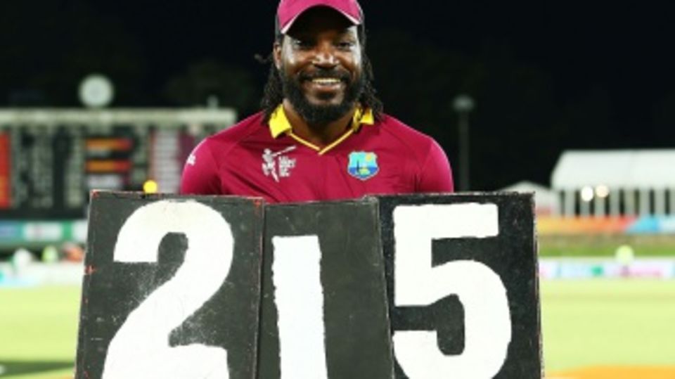 It's all mine: Chris Gayle holds the scoring plates that shout out his record