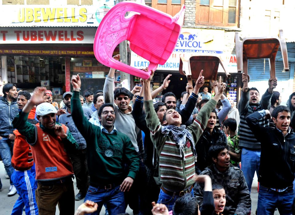 Who you gonna support? Kashmiris in Srinagar celebrate the fall of an Indian wicket during the India-Pakistan World Cup semi-final in 2011
