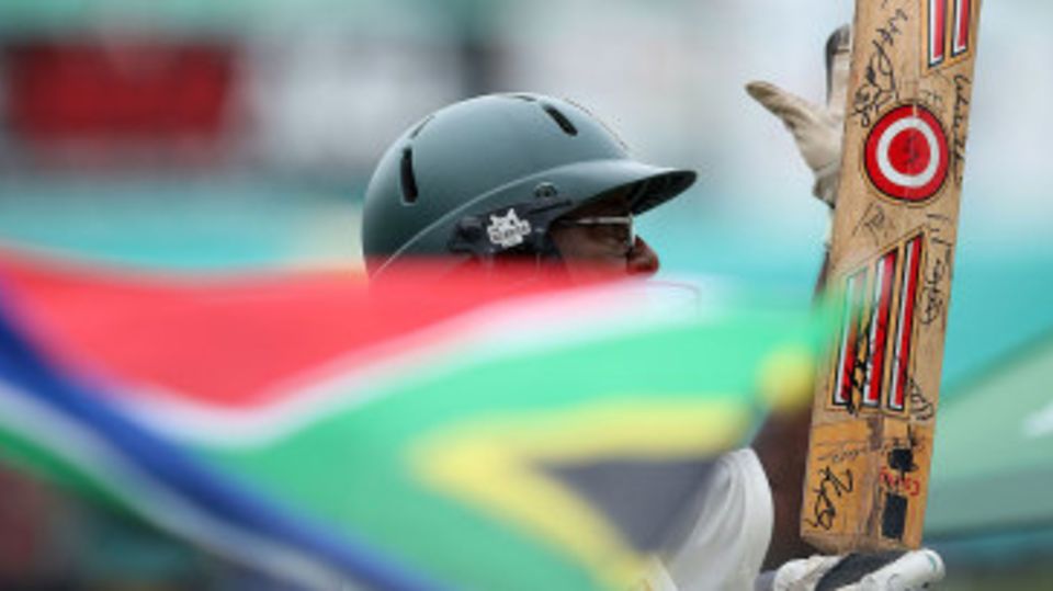 The South Africa flag waves as a fan looks on
