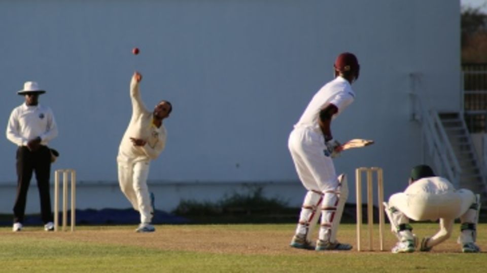 Fawad Ahmed sends down a delivery to Roston Chase