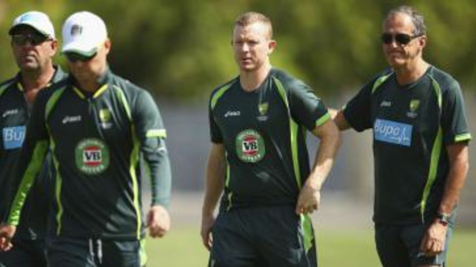 Chris Rogers with team doctor Peter Brukner after being struck on the helmet at training