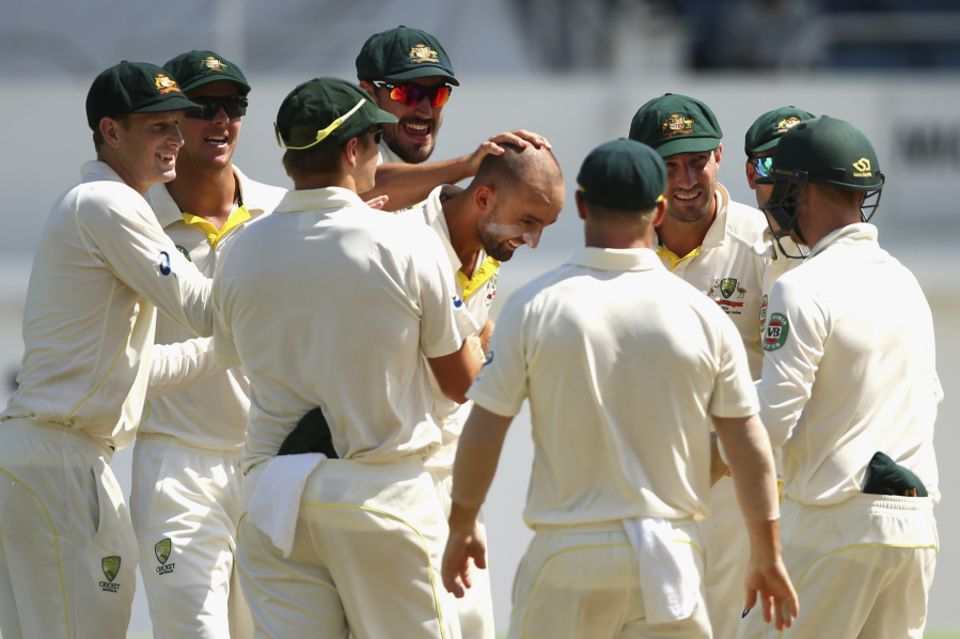 Nathan Lyon is swarmed after taking the wicket of Darren Bravo