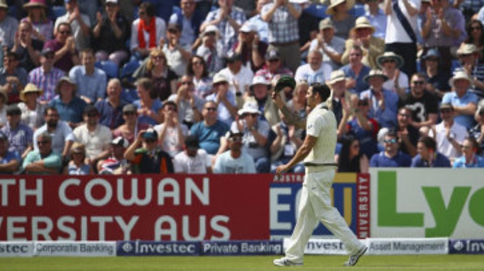 Mitchell Johnson raises his cap to the crowd after conceding his century