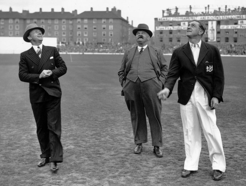 Don Bradman and Wally Hammond toss, watched by groundsman Bosser Martin