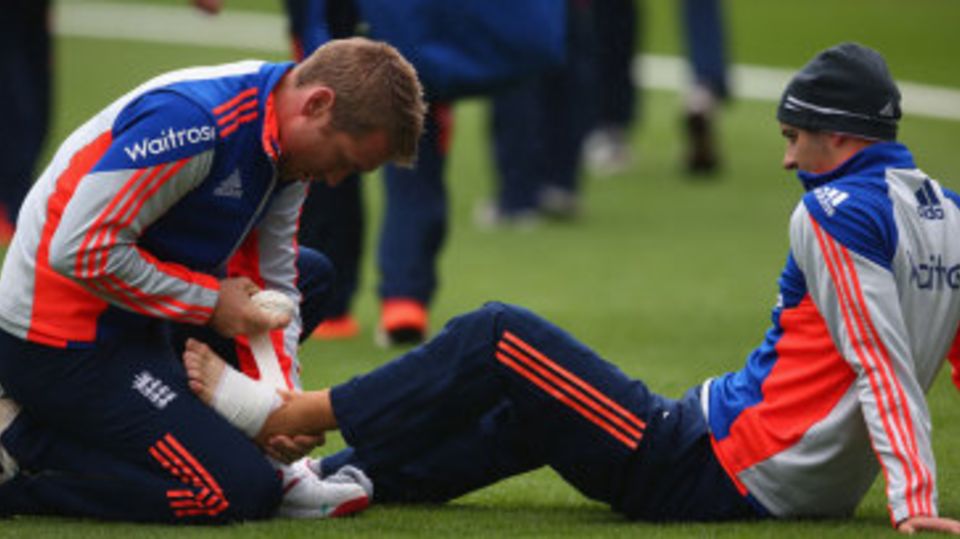 Mark Wood receives treatment on his foot