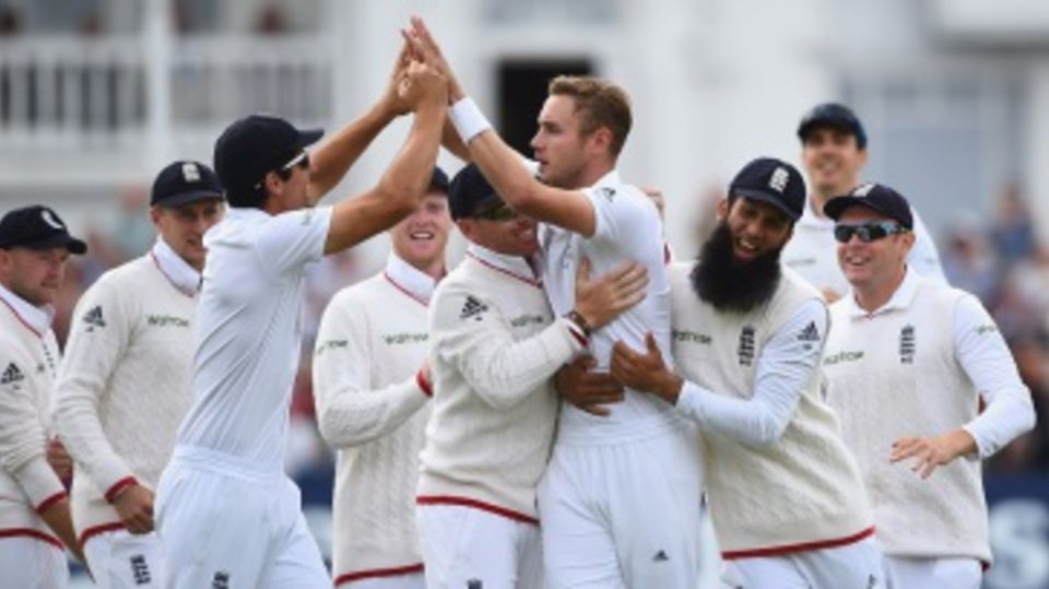 Stuart Broad is mobbed by his team-mates after reaching 300 Test wickets