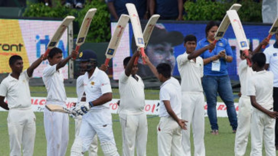 Kumar Sangakkara is given a guard of honour as he walks in to bat