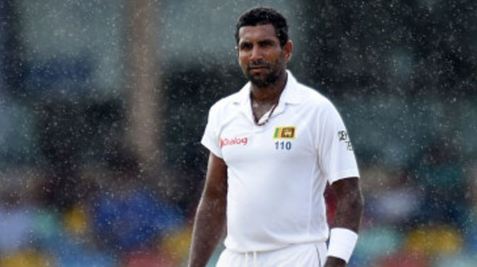Dhammika Prasad looks on amidst the rain