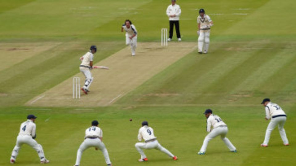 Adam Lyth stoops to take a catch off Ryan Sidebottom's bowling