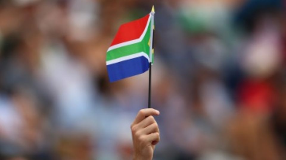 A fan holds the South African flag aloft