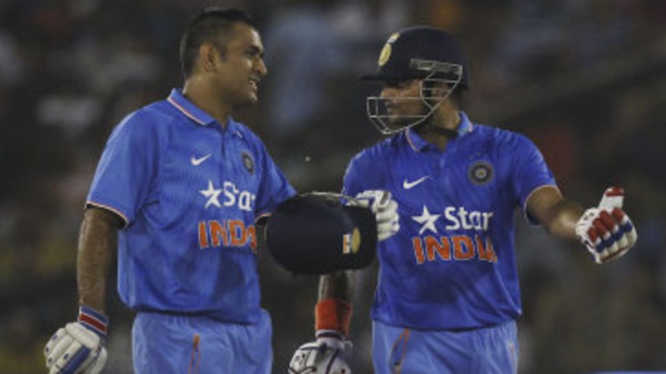 MS Dhoni and Suresh Raina chat during their fifth-wicket stand