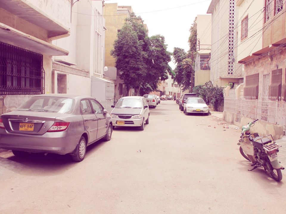 Mind the windows: an influx of cars has led to a space crunch for cricket in the streets, like in Nazimabad above