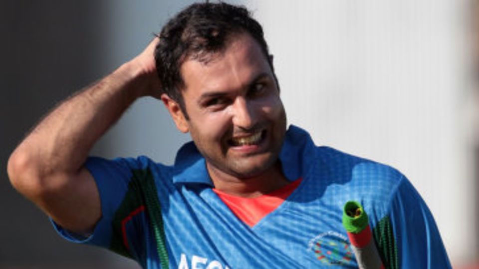 A smiling Mohammad Nabi walks back after steering Afghanistan to victory
