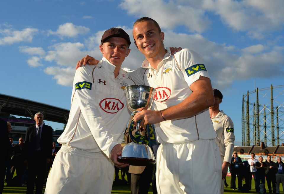 Brothers keepers: Sam (left) and Tom Curran hold aloft the spoils after Surrey took the Division Two title this year