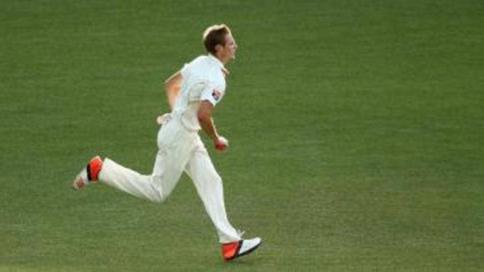 Joe Mennie runs in to bowl