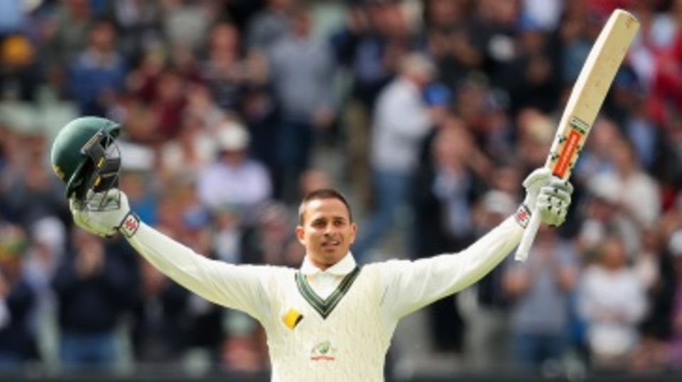 Usman Khawaja celebrates after reaching his century
