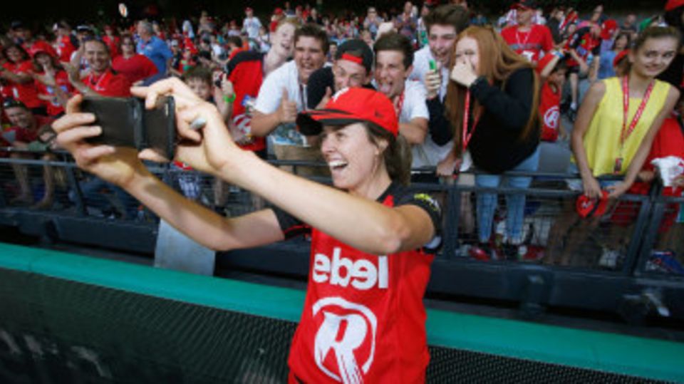 Molly Strano takes a photo with fans after the game