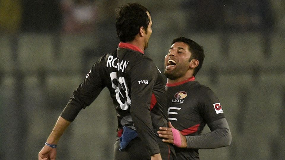 Rohan Mustafa and Mohammad Naveed bump chests to celebrate a wicket