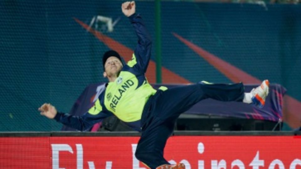 Gary Wilson leaps in the air to save a six