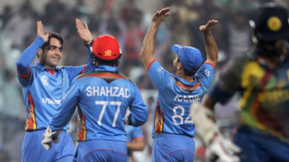 Rashid Khan is congratulated after dismissing Lahiru Thirimanne