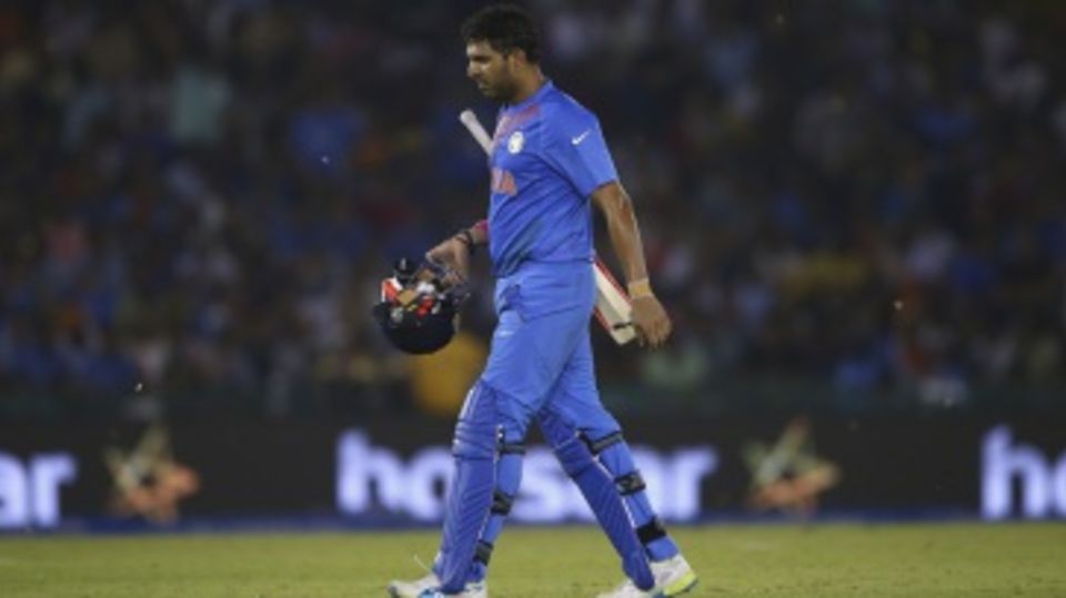 Yuvraj Singh walks back after being dismissed