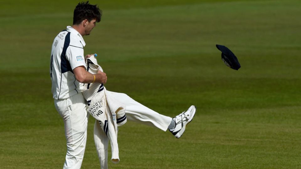Steven Finn kicks away his cap in frustration
