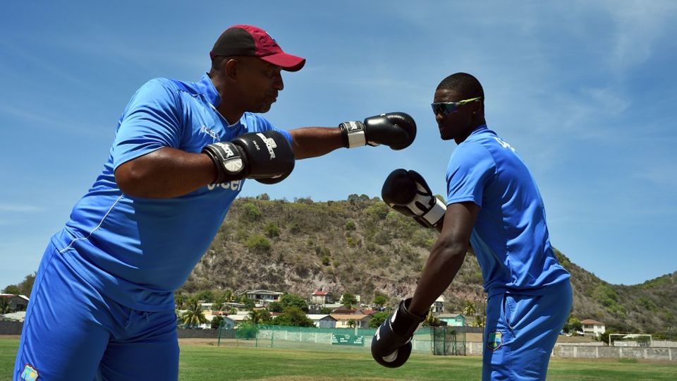 Put 'em up: West Indies coach Phil Simmons boxes with captain Jason Holder