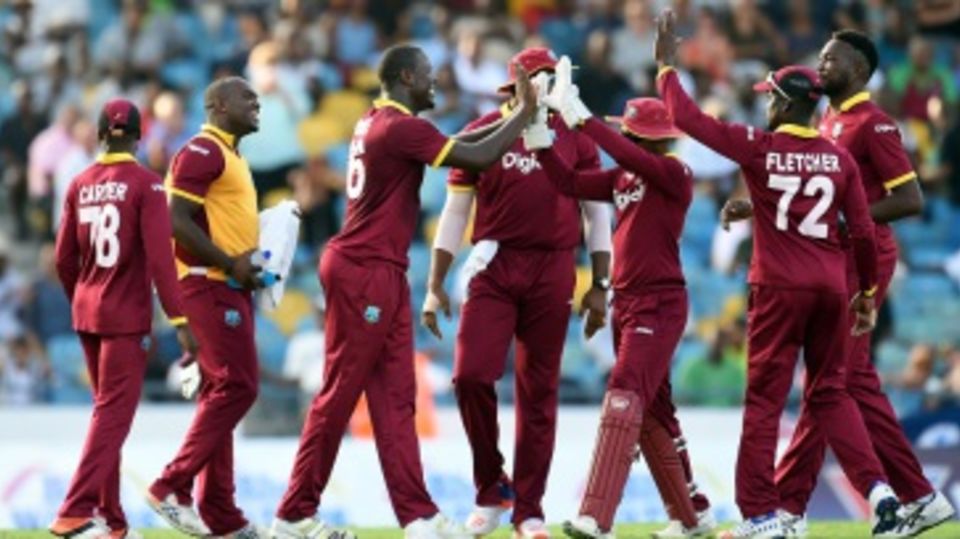 Carlos Brathwaite is mobbed by his team-mates