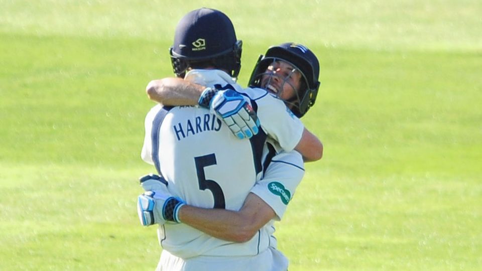 John Simpson and James Harris embrace after victory against Somerset at Taunton
