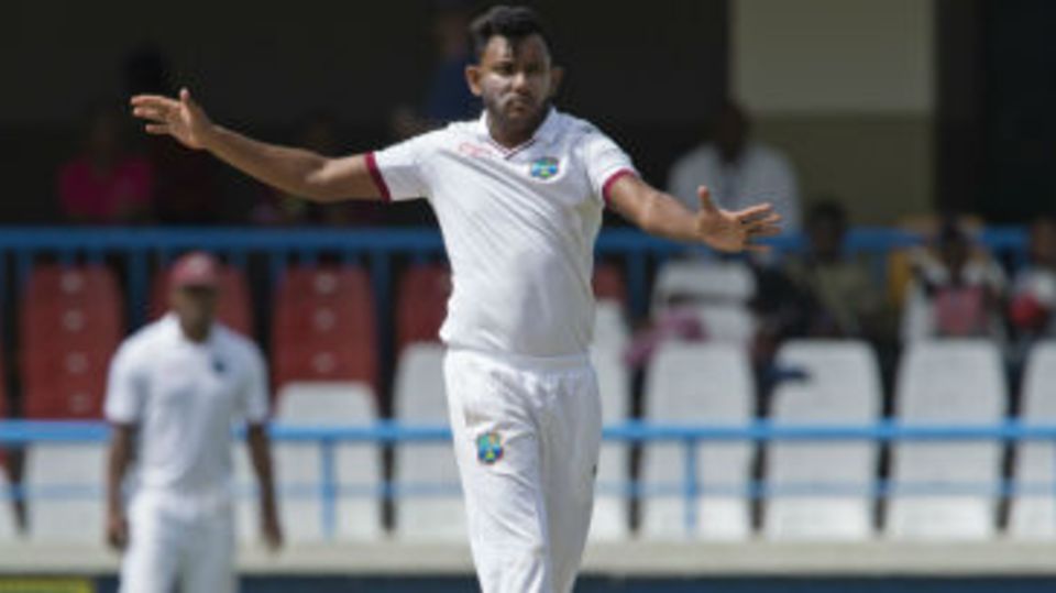 Devendra Bishoo celebrates the wicket of Shikhar Dhawan