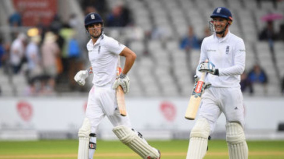 Alex Hales and Alastair Cook run from the field during a rain break