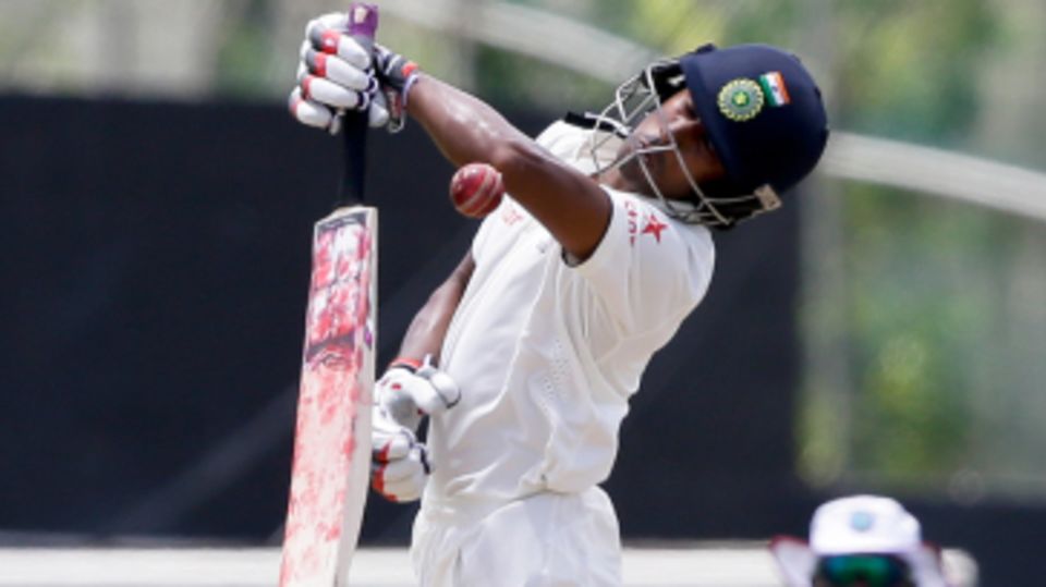 Wriddhiman Saha tries to fend off a short ball