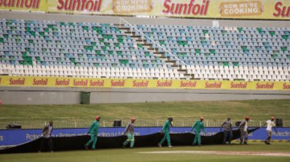 Ground staff bring on the covers at Kingsmead