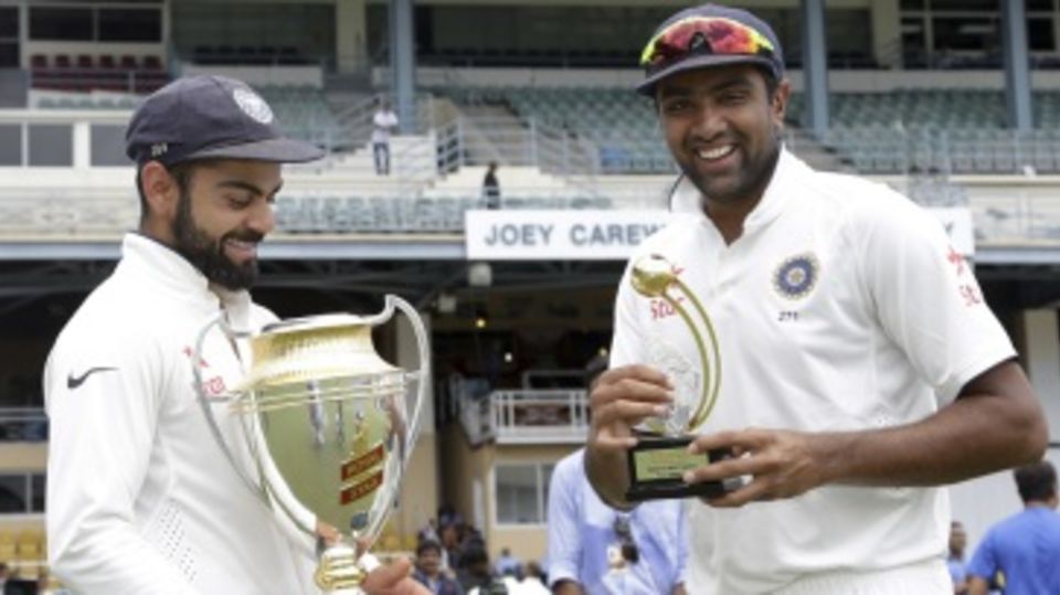 Virat Kohli poses with the series trophy, R Ashwin with the Man-of-the-series award