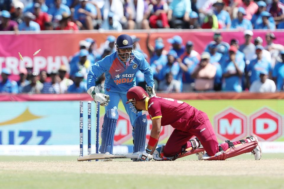 Lendl Simmons was done in by R Ashwin, who fired a full delivery down leg to have him stumped with a wide