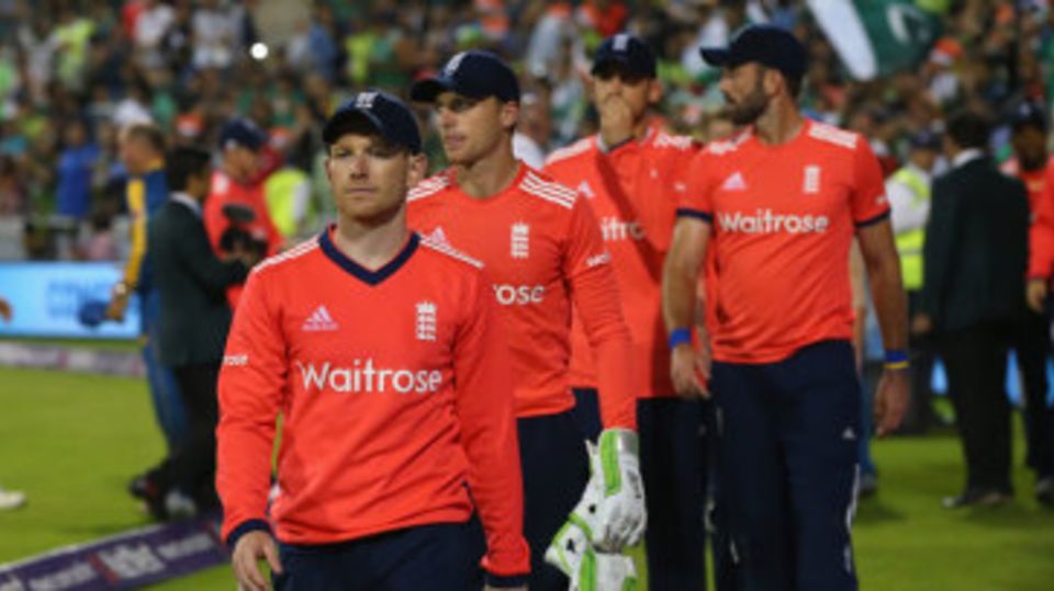 Eoin Morgan leads his beaten team from the field