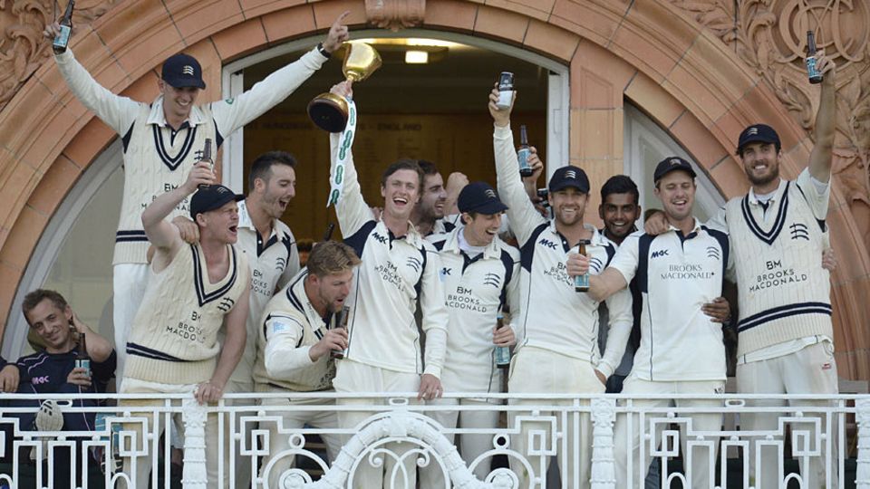 The Middlesex players celebrate their 2016 title on the balcony at Lord's