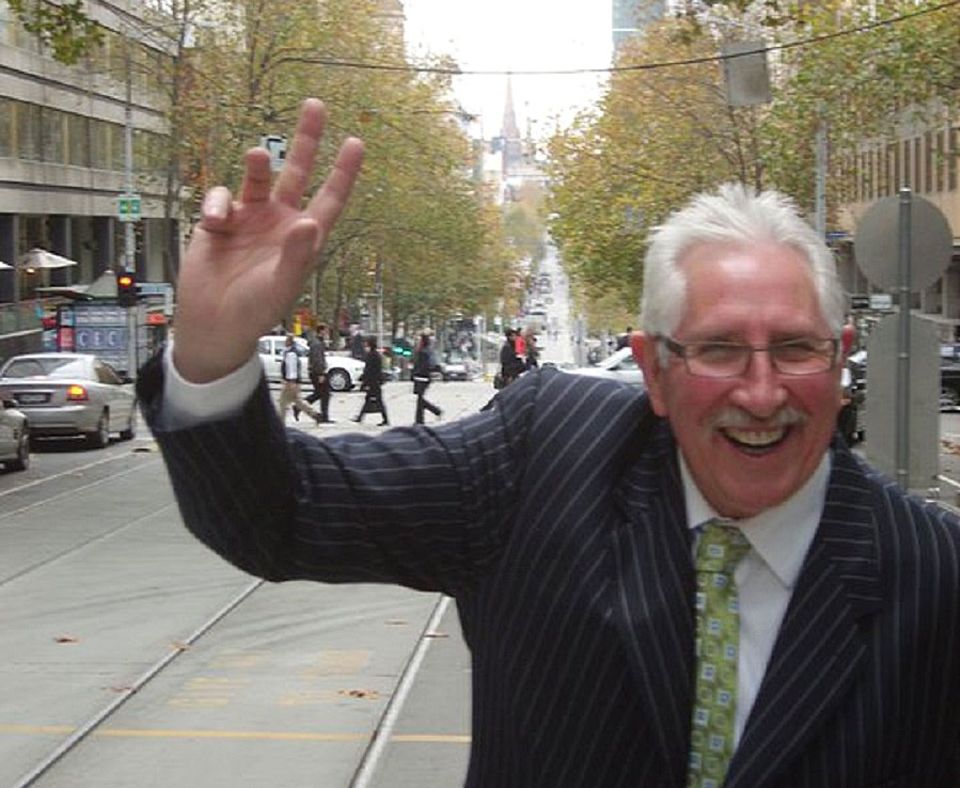 Suit up, Tangles: Walker tries to demonstrate his bowling action in a Melbourne street