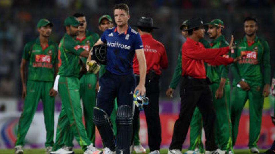 The umpires try to calm tensions as Jos Buttler departs