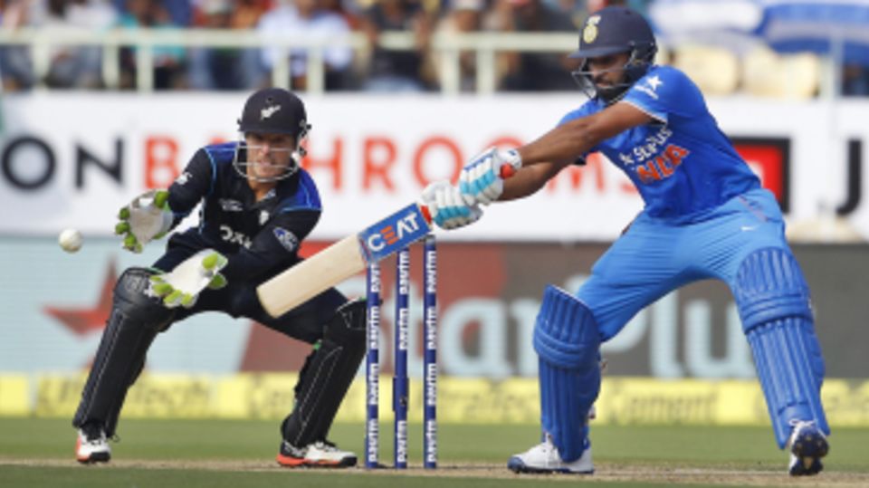 Rohit Sharma goes back to guide the ball