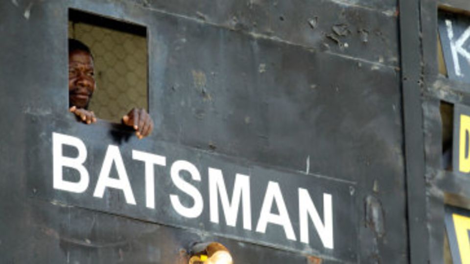 A scoreboard operator watches play at the Harare Sports Club