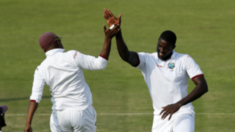 Jason Holder celebrates dismissing opener Sami Aslam