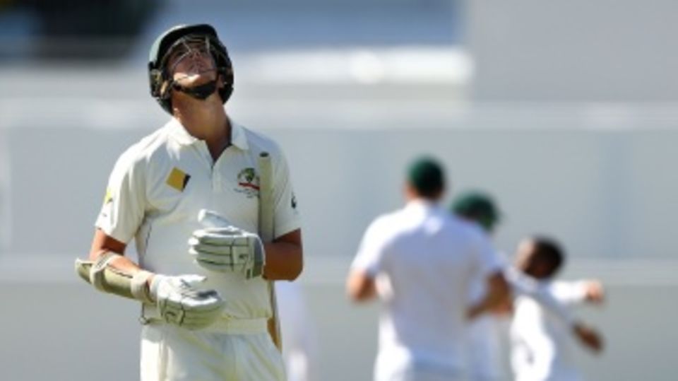 A dejected Josh Hazlewood walks back after falling as the ninth wicket