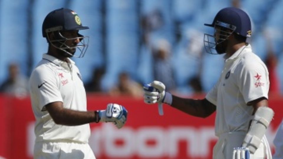 Cheteshwar Pujara congratulates M Vijay on his 15th Test fifty