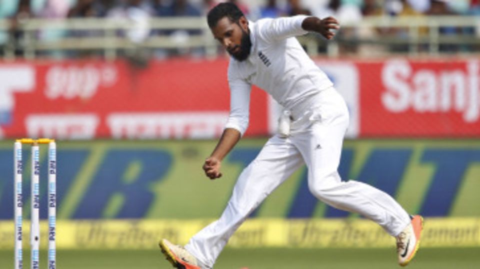 Adil Rashid fields the ball off his own bowling