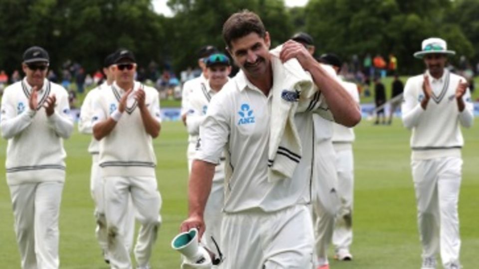 Debutant Colin de Grandhomme is applauded by team-mates as he leads them off the ground